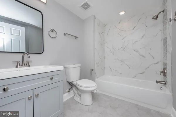 a bathroom with a sink a toilet and a bathtub