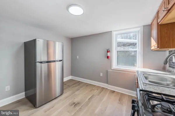 a kitchen with a refrigerator and a sink