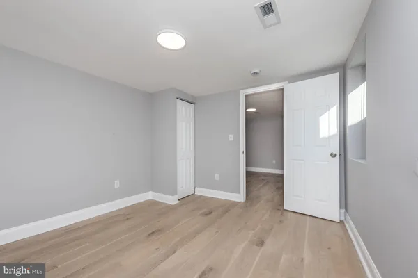 a view of an empty room with wooden floor
