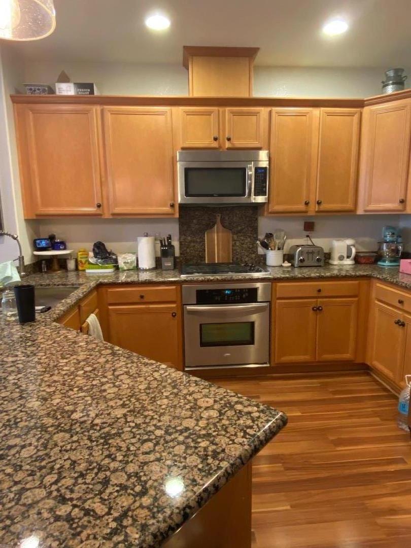 204 Sullivan Way Hayward, CA 94541 - Photo 3 of 8 a kitchen with stainless steel appliances granite countertop a sink stove and refrigerator