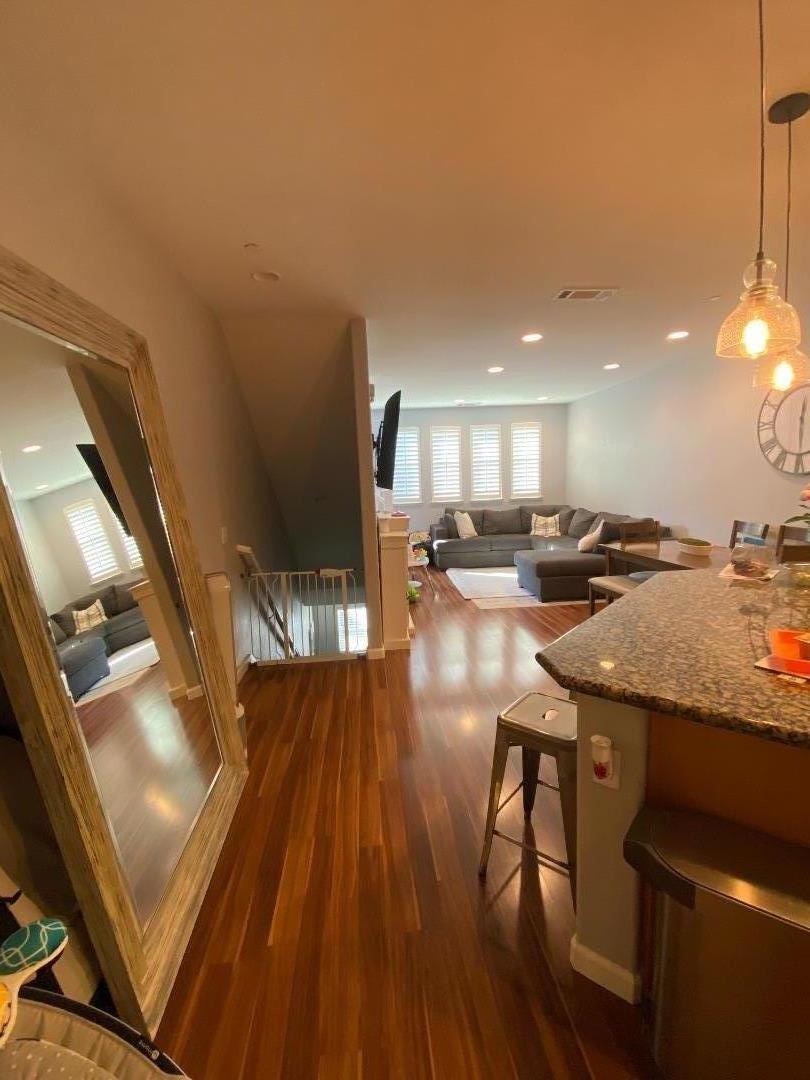 204 Sullivan Way Hayward, CA 94541 - Photo 4 of 8 a kitchen with a sink dishwasher a dining table and chairs with wooden floor