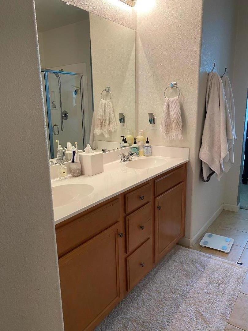 204 Sullivan Way Hayward, CA 94541 - Photo 7 of 8 a bathroom with a double vanity sink and a mirror