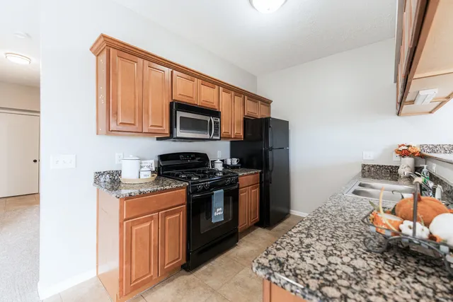a kitchen with stainless steel appliances granite countertop a stove and a sink