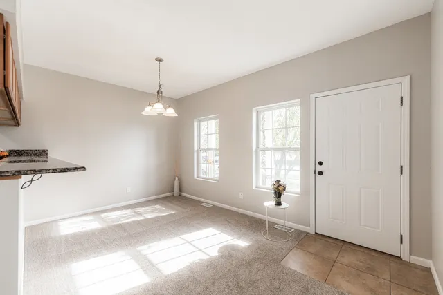 a view of a livingroom with a fireplace and window