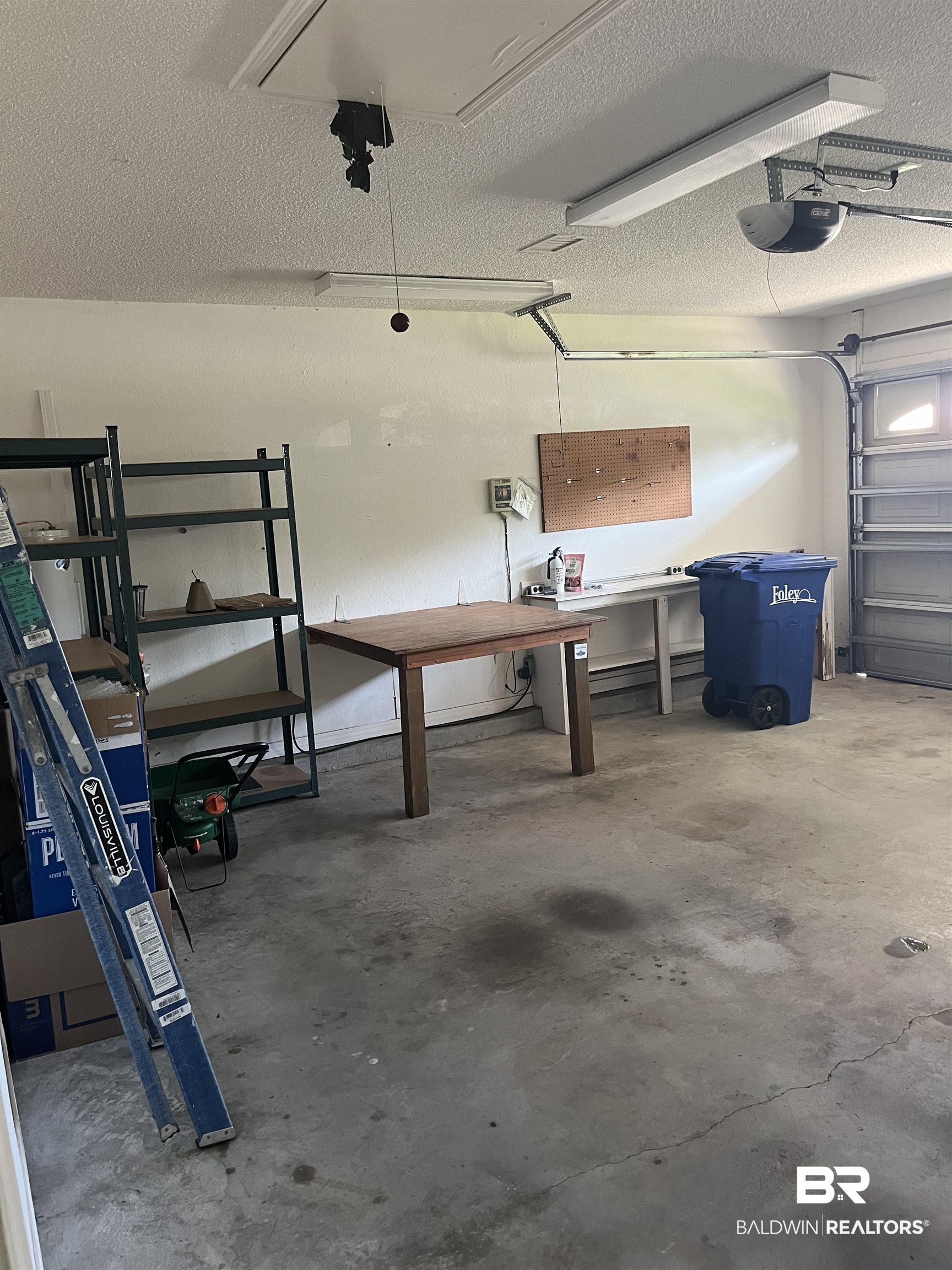 309 Cluster Street Foley, AL 36535 - Photo 29 of 38 Spacious garage with concrete flooring, overhead fluorescent lighting, and an automatic garage door opener