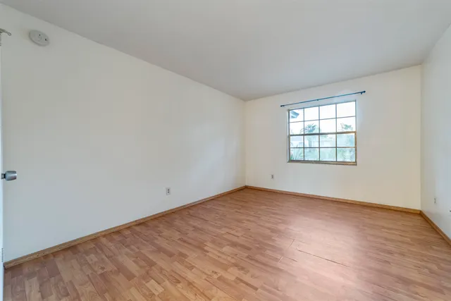 a view of an empty room and wooden floor