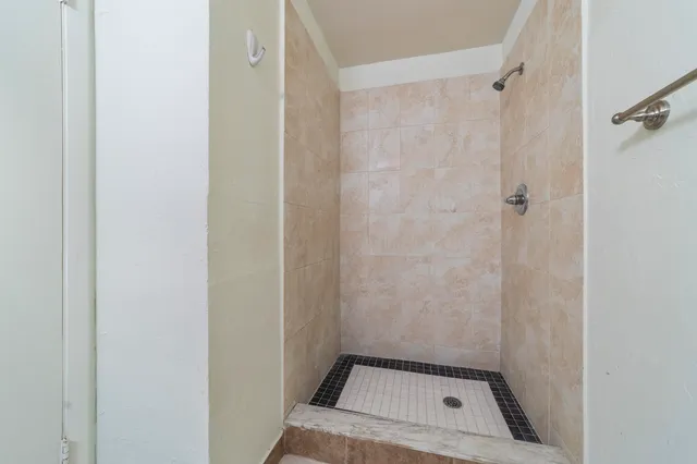 a kitchen with granite countertop a refrigerator and a stove top oven