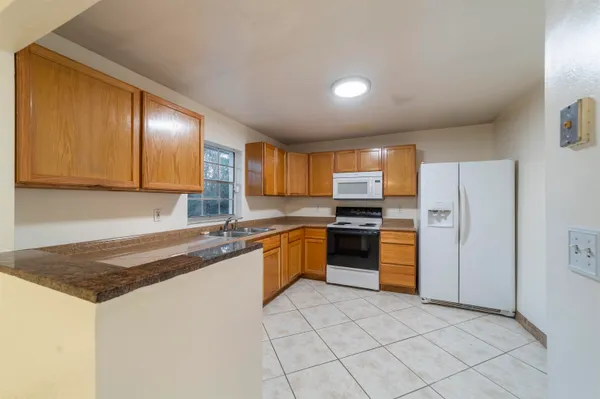 a kitchen with stainless steel appliances granite countertop a sink stove and cabinets