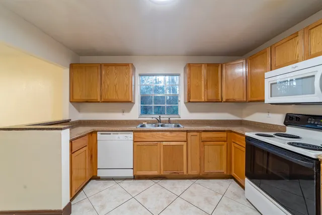a spacious bathroom with a granite countertop sink a mirror and a shower