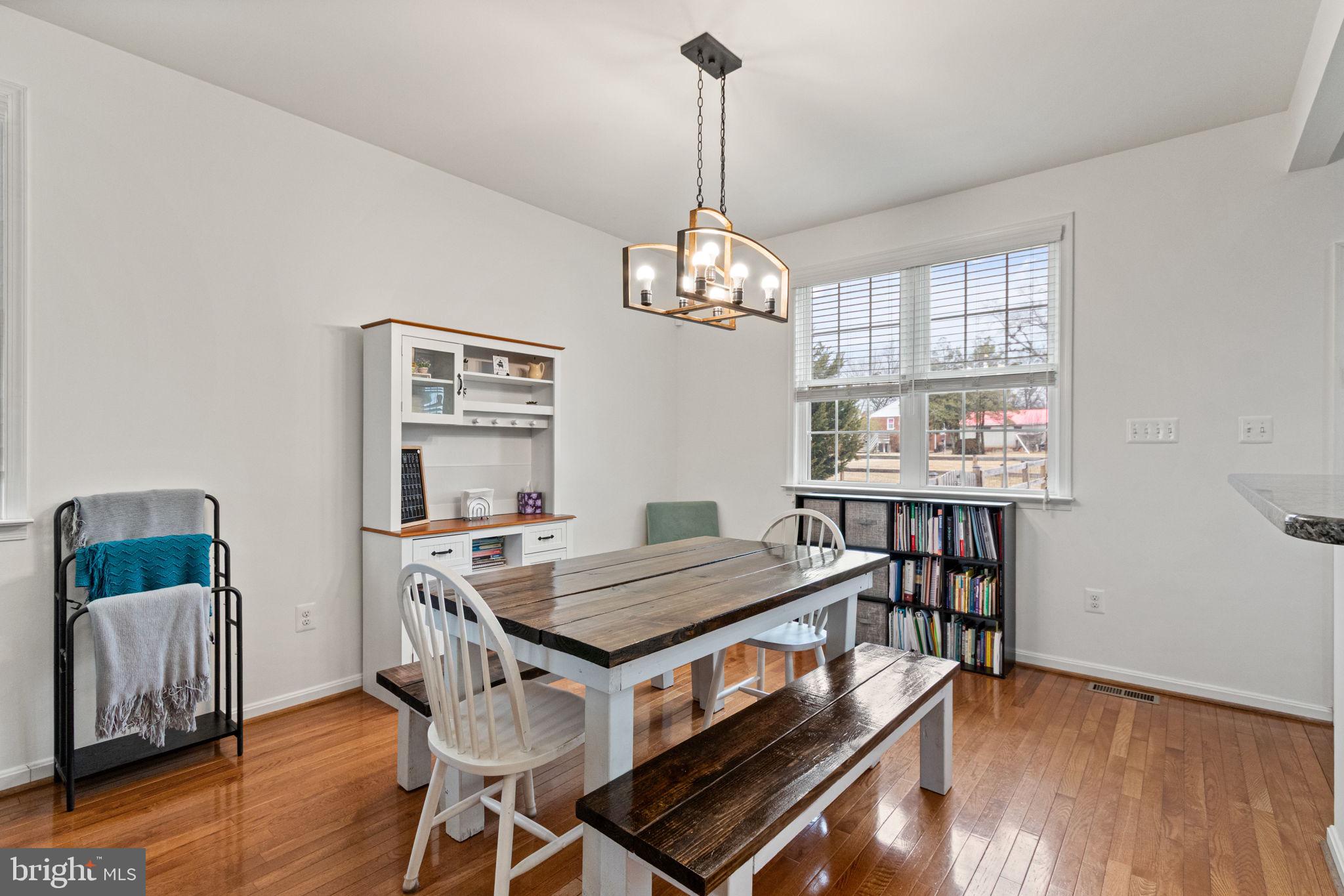 11055 Ransom Lane Bealeton, VA 22712 - Photo 12 of 45 a view of a dining room with furniture wooden floor and chandelier