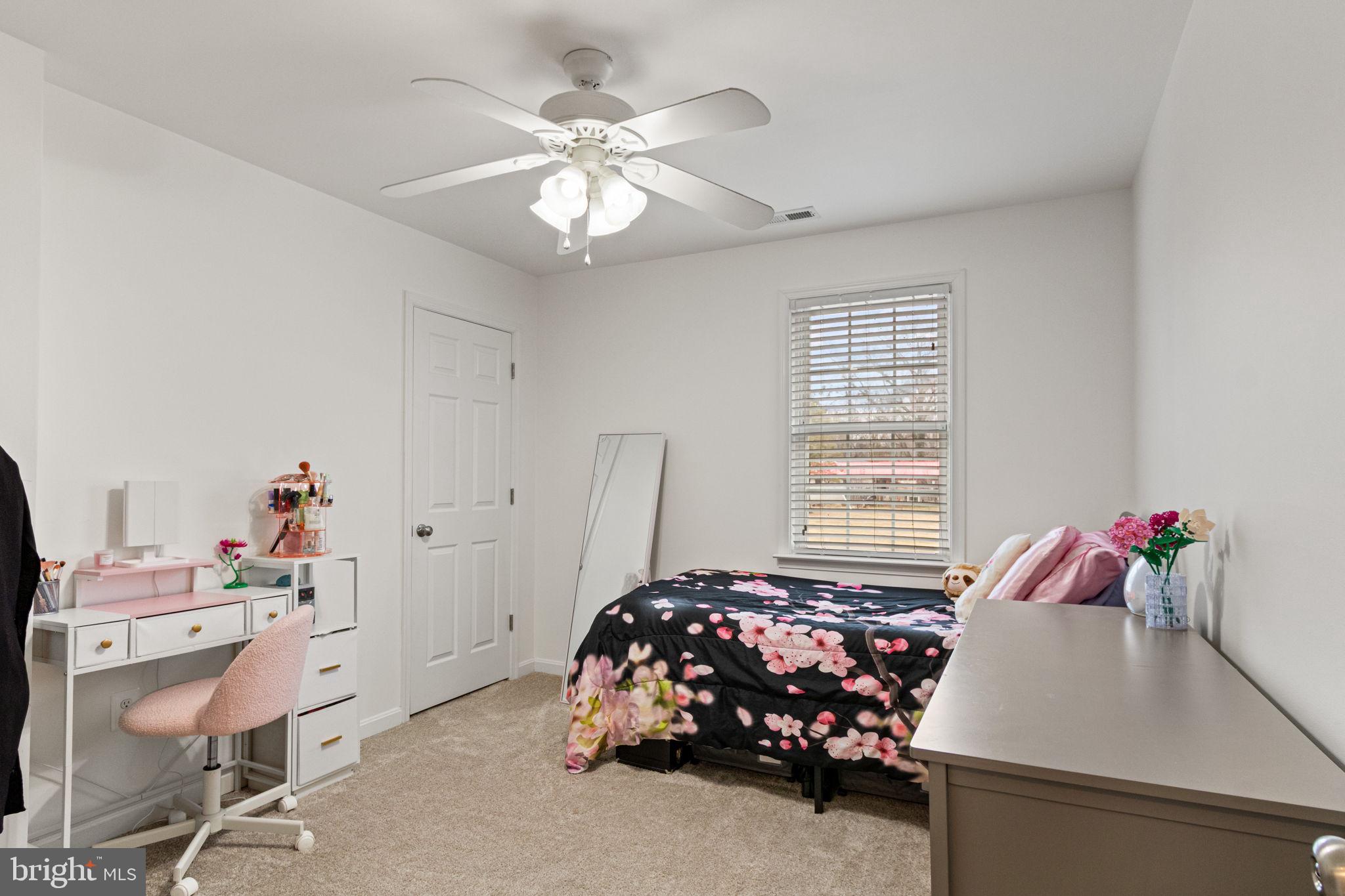 11055 Ransom Lane Bealeton, VA 22712 - Photo 25 of 45 a bedroom with a bed and a chandelier