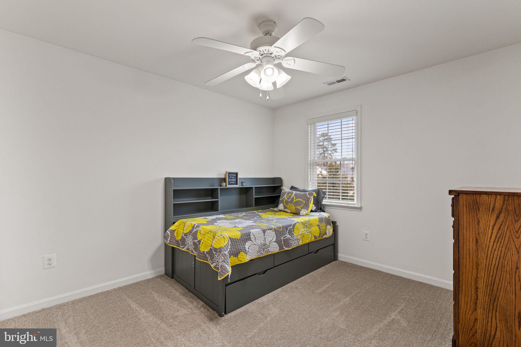 11055 Ransom Lane Bealeton, VA 22712 - Photo 28 of 45 a bedroom with a bed and a chandelier