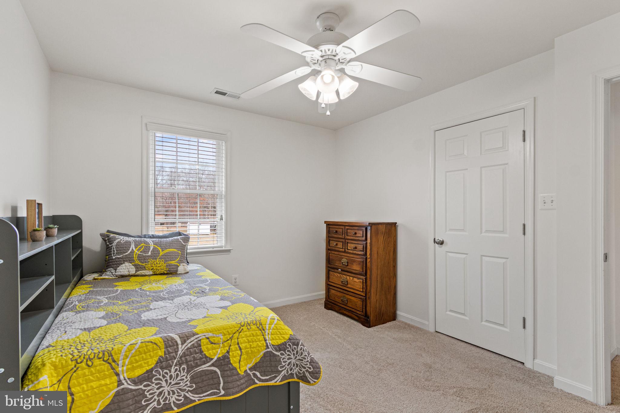 11055 Ransom Lane Bealeton, VA 22712 - Photo 29 of 45 a bedroom with a bed and a chandelier