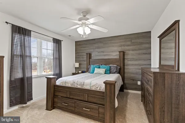 a bedroom with a bed and a dresser