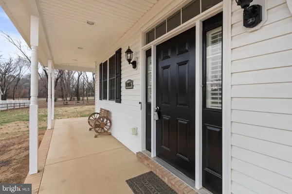 a view of a porch with wooden floor and stairs