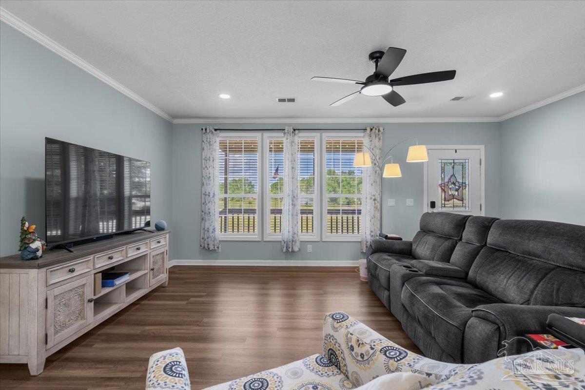 4955 Blue Ribbon Drive Milton, FL 32583 - Photo 7 of 32 a living room with furniture and a flat screen tv