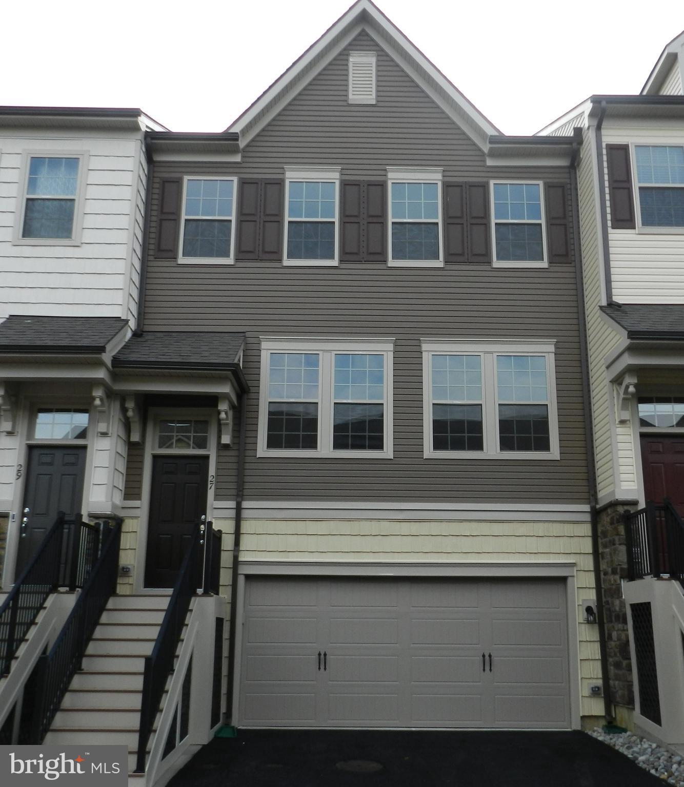 a front view of a house with many windows