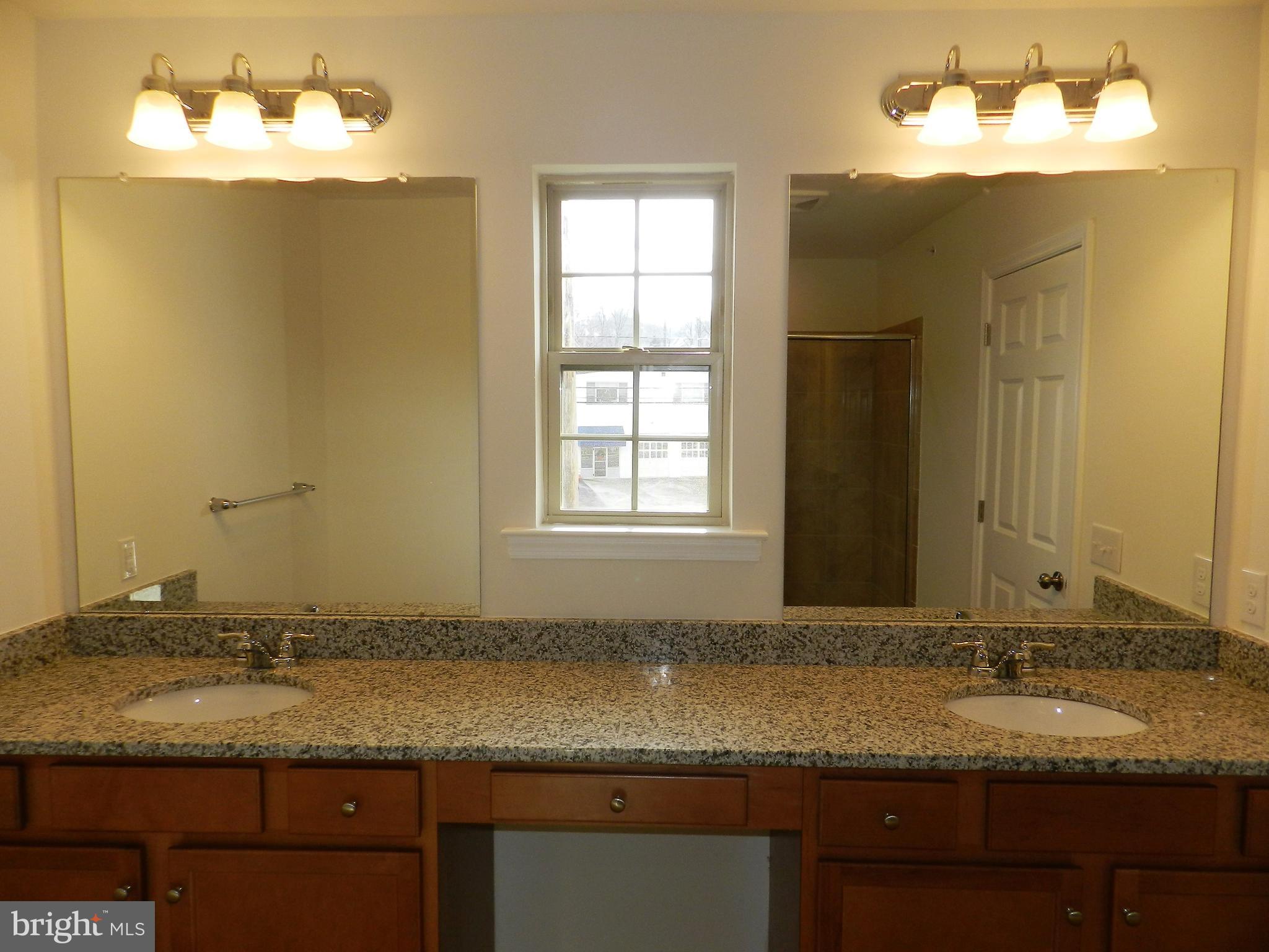 27 Eagle Lane Malvern, PA 19355 - Photo 12 of 24 a bathroom with a granite countertop sink and a mirror