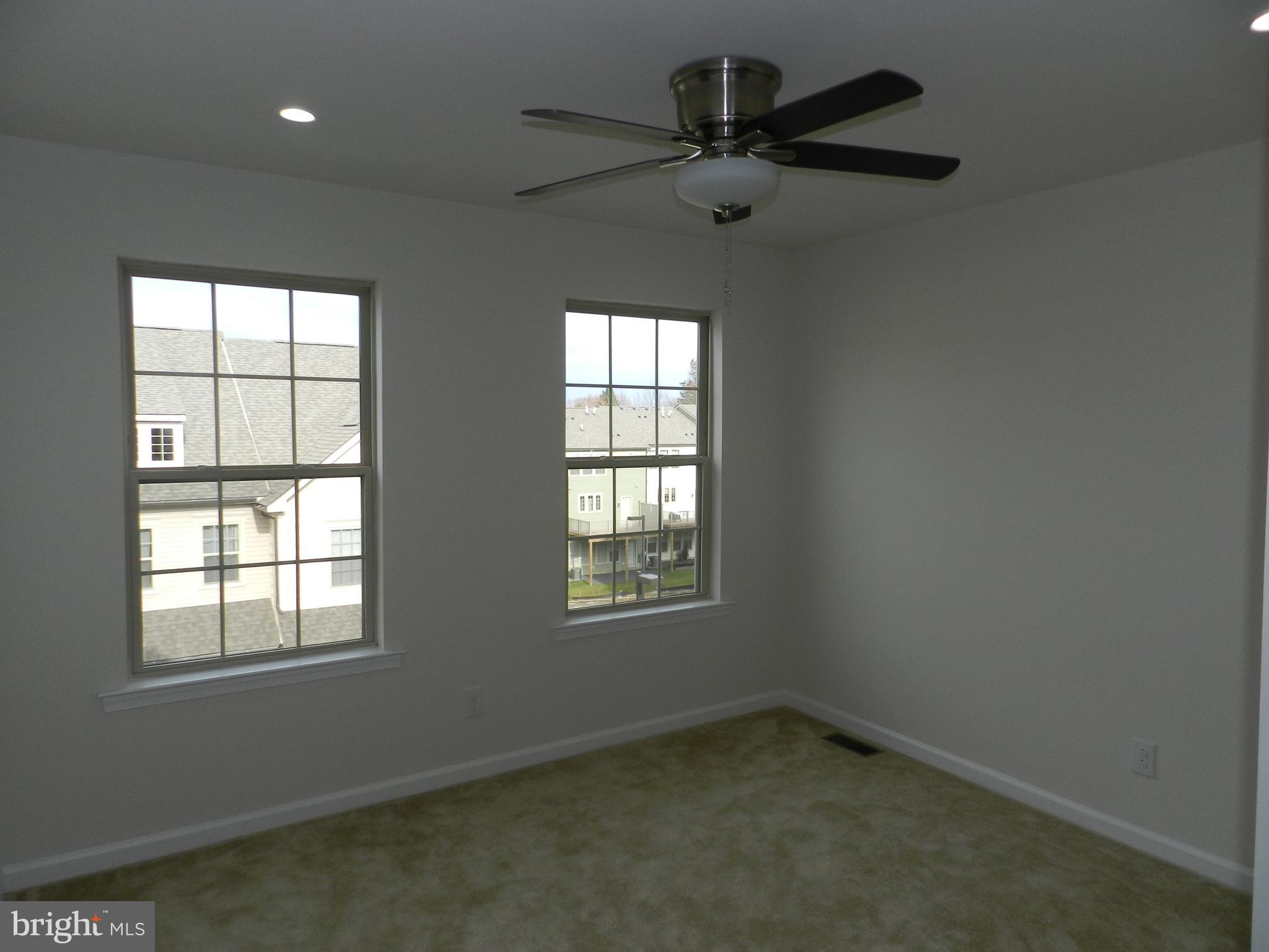 27 Eagle Lane Malvern, PA 19355 - Photo 16 of 24 an empty room with a window and a fan