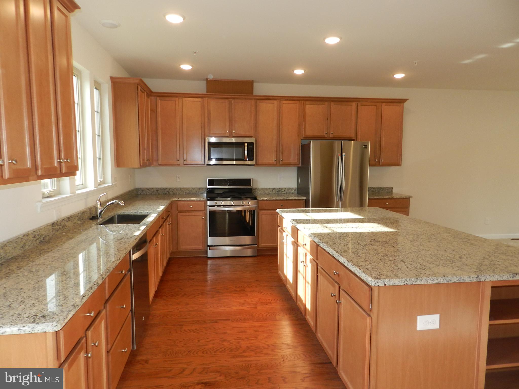 27 Eagle Lane Malvern, PA 19355 - Photo 2 of 24 a large kitchen with stainless steel appliances granite countertop a stove a sink and a refrigerator