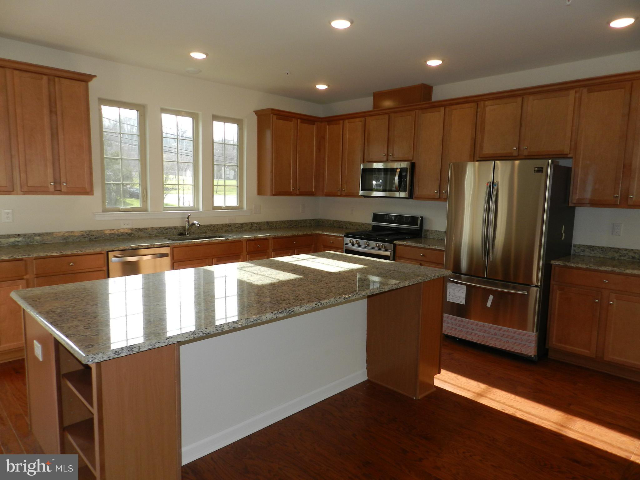 27 Eagle Lane Malvern, PA 19355 - Photo 4 of 24 a kitchen with stainless steel appliances granite countertop a refrigerator a sink and a stove