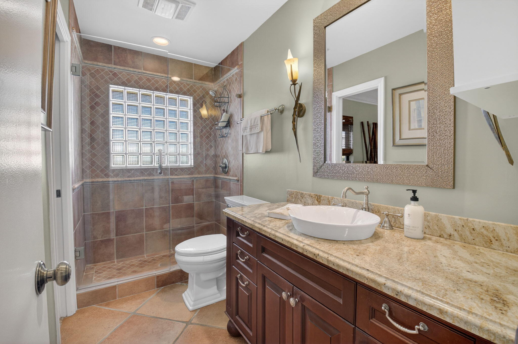 5470 Northwest 3rd Terrace Boca Raton, FL 33487 - Photo 39 of 72 a bathroom with a granite countertop sink a toilet a mirror and shower