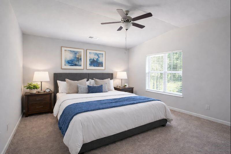 6343 Towhee Way Morrow, GA 30260 - Photo 5 of 36 a bedroom with a bed and a chandelier