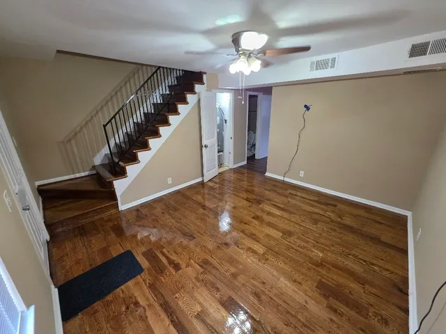 a view of entryway and hall with wooden floor