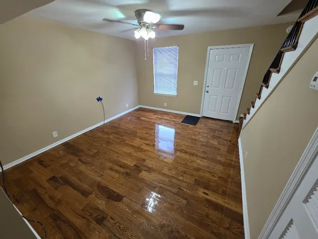 wooden floor in an empty room with a window