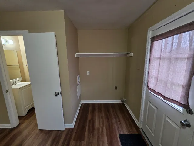 a view of room with window and hardwood floor