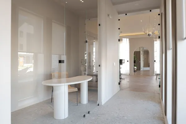 a view of a hallway with dining table and chairs