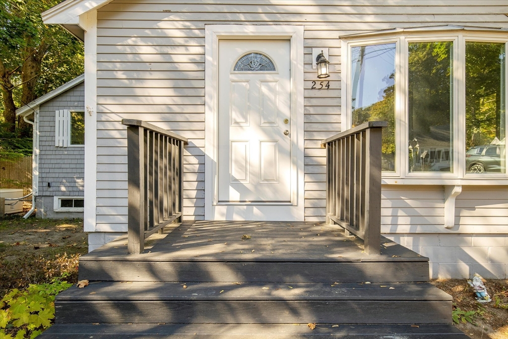 254 Barlows Landing Road Bourne, MA 02559 - Photo 2 of 27 a front view of a house with a yard