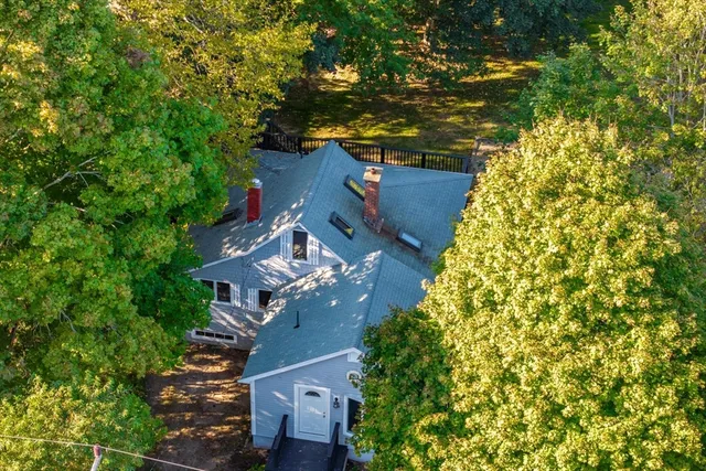an aerial view of a house with a yard