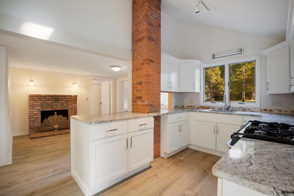 254 Barlows Landing Road Bourne, MA 02559 - Photo 8 of 27 a kitchen with a white cabinets and wooden floor