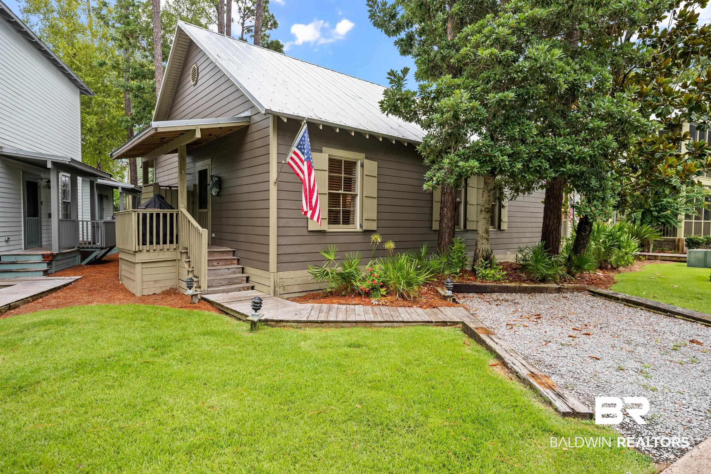 25773 Canal Road, Unit 18 Orange Beach, AL 36561 - Photo 23 of 44 Bungalow featuring a front lawn and a metal roof