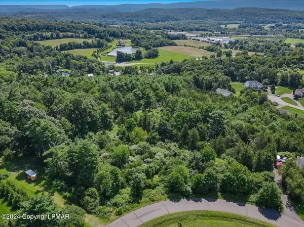 an aerial view of a houses with a lake view