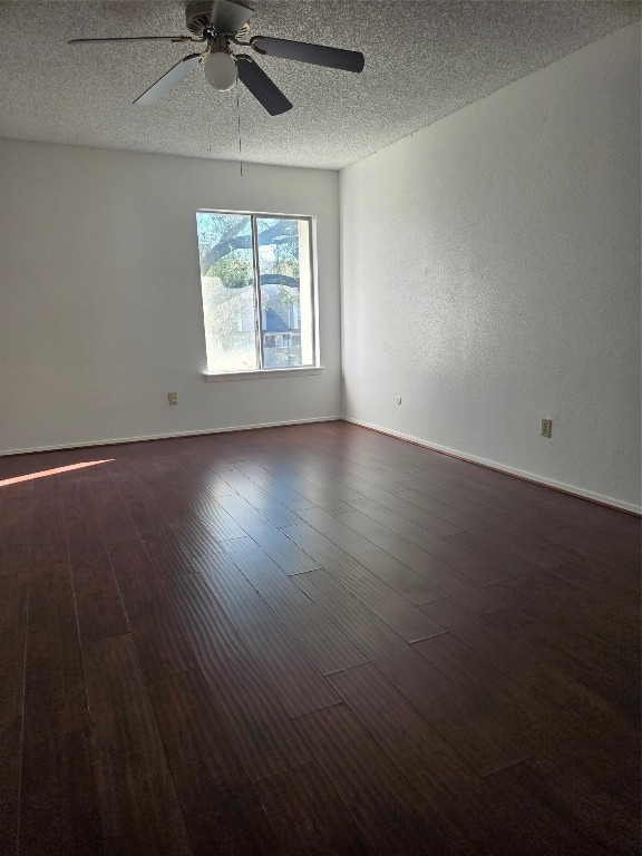 12906 Leader Street, Unit 2906 Houston, TX 77072 - Photo 11 of 16 an empty room with wooden floor chandelier fan and windows