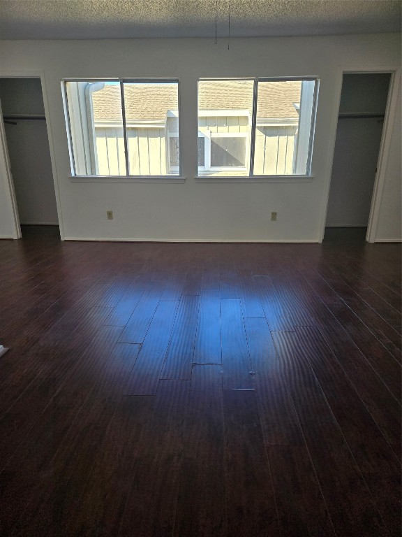 12906 Leader Street, Unit 2906 Houston, TX 77072 - Photo 12 of 16 an empty room with wooden floor and windows