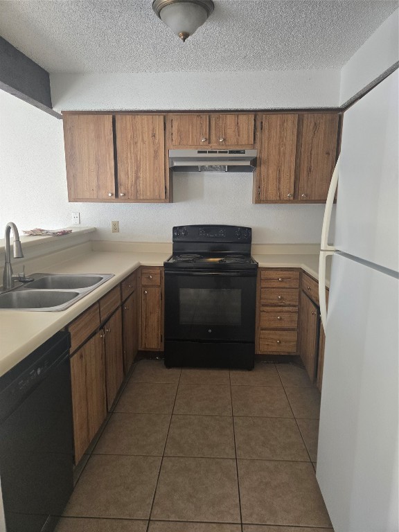 12906 Leader Street, Unit 2906 Houston, TX 77072 - Photo 7 of 16 a kitchen with a cabinets and a refrigerator
