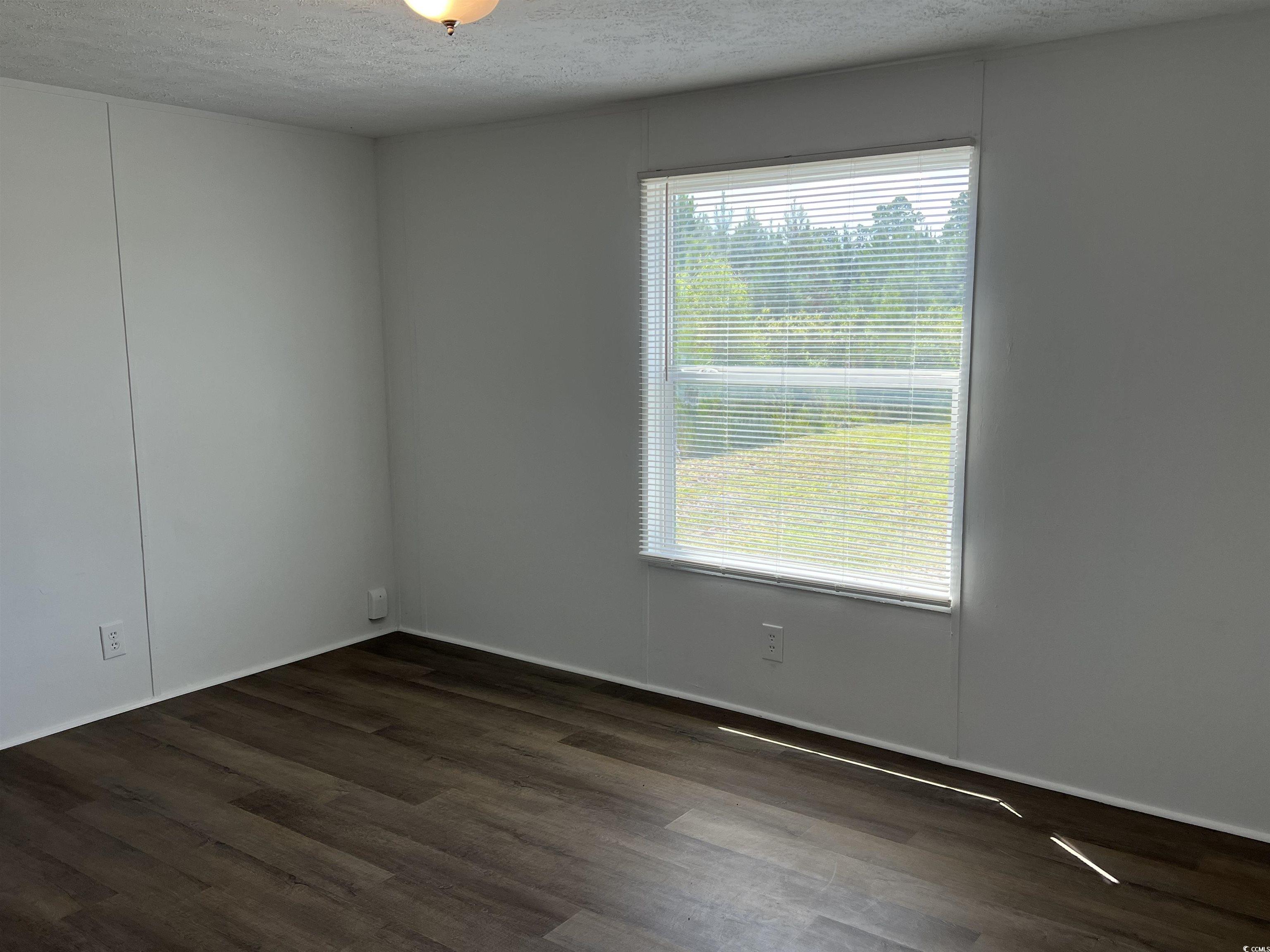 3596 Henry Road Aynor, SC 29511 - Photo 11 of 15 Spare room with a textured ceiling, a healthy amou
