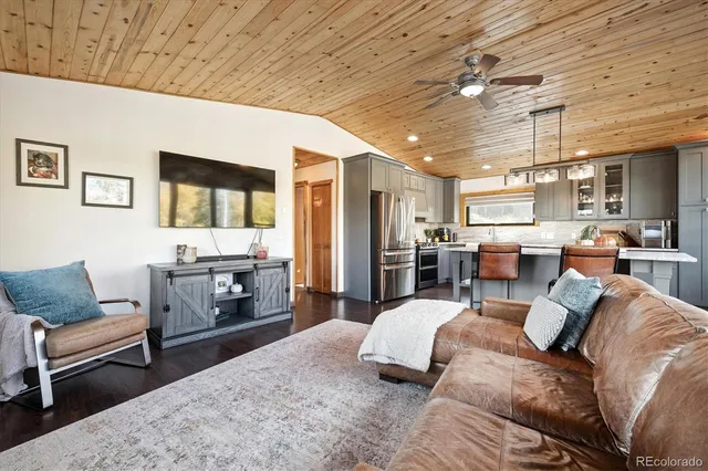a bedroom with furniture and a kitchen