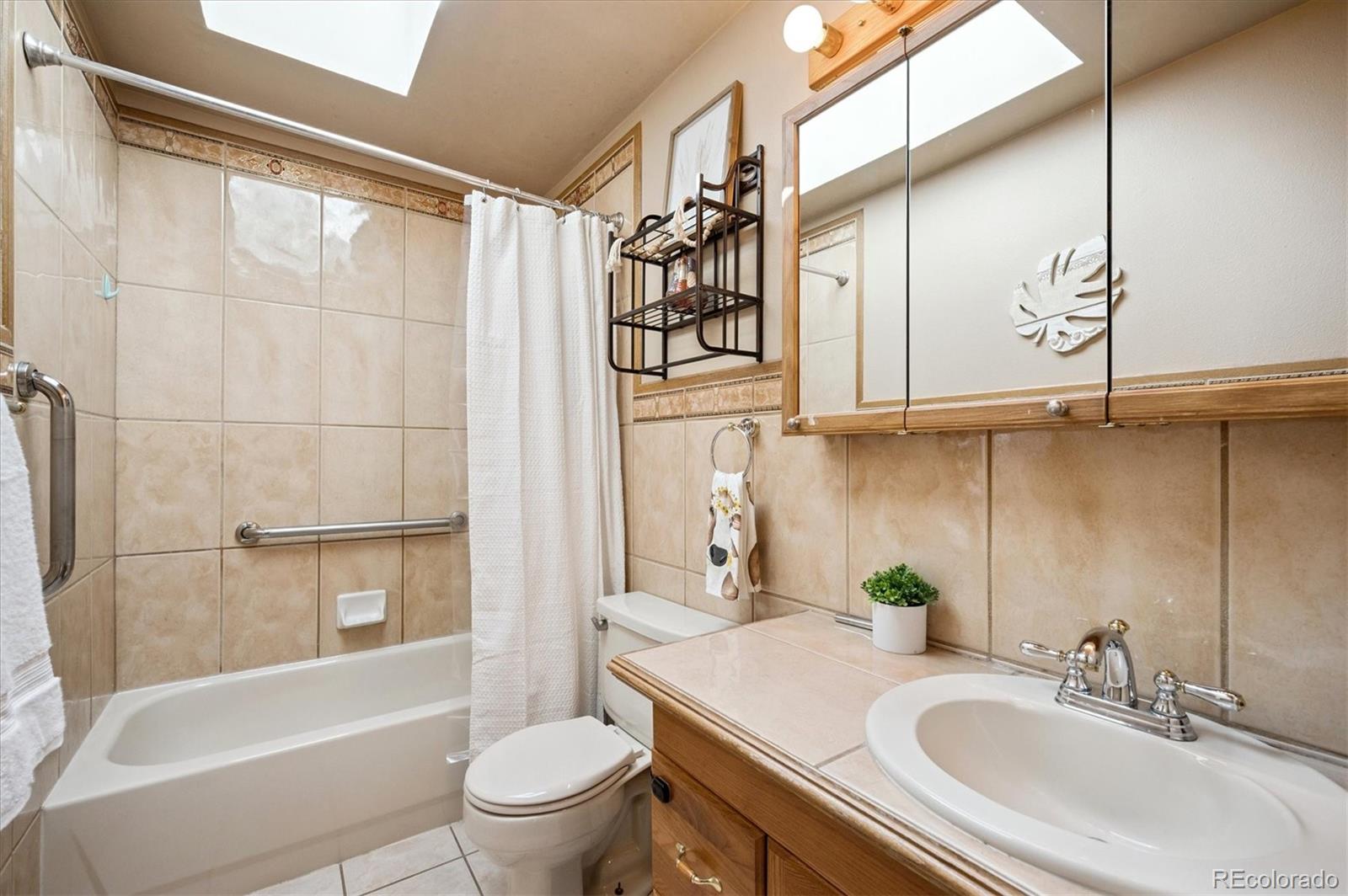 12369 Quartz Spur Conifer, CO 80433 - Photo 16 of 36 a bathroom with a sink a toilet and a bathtub