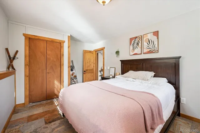 a bedroom with a large bed and a dresser