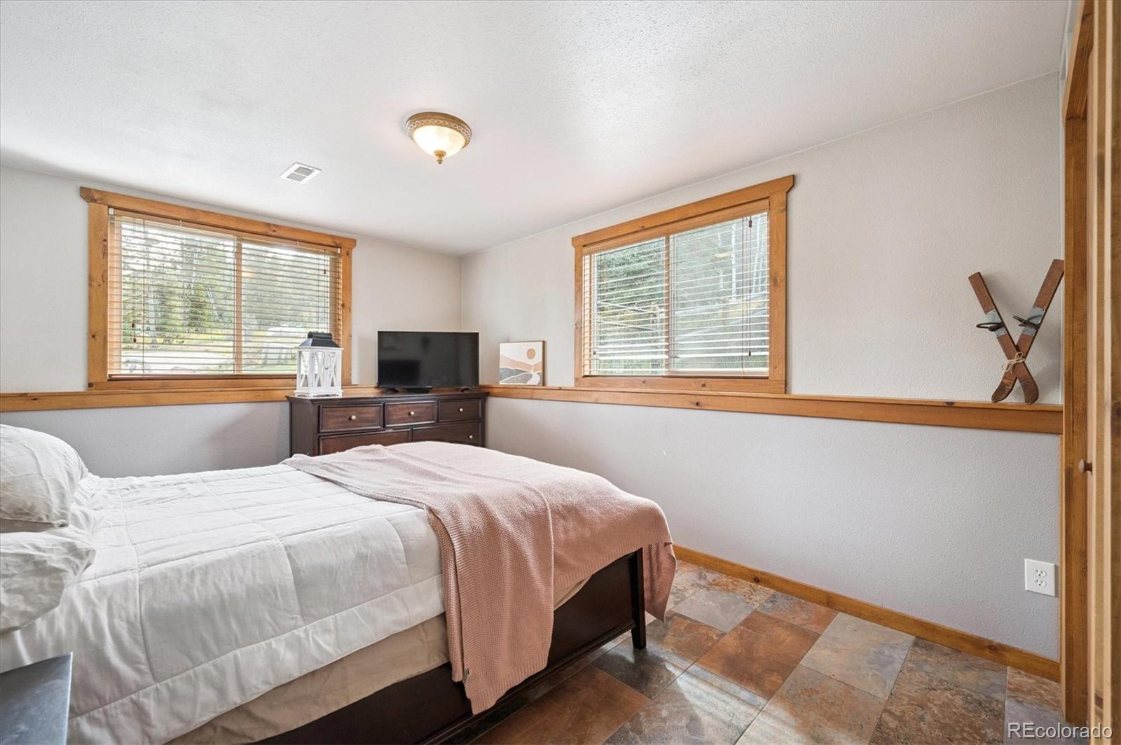 12369 Quartz Spur Conifer, CO 80433 - Photo 18 of 36 a bedroom with a bed and a window