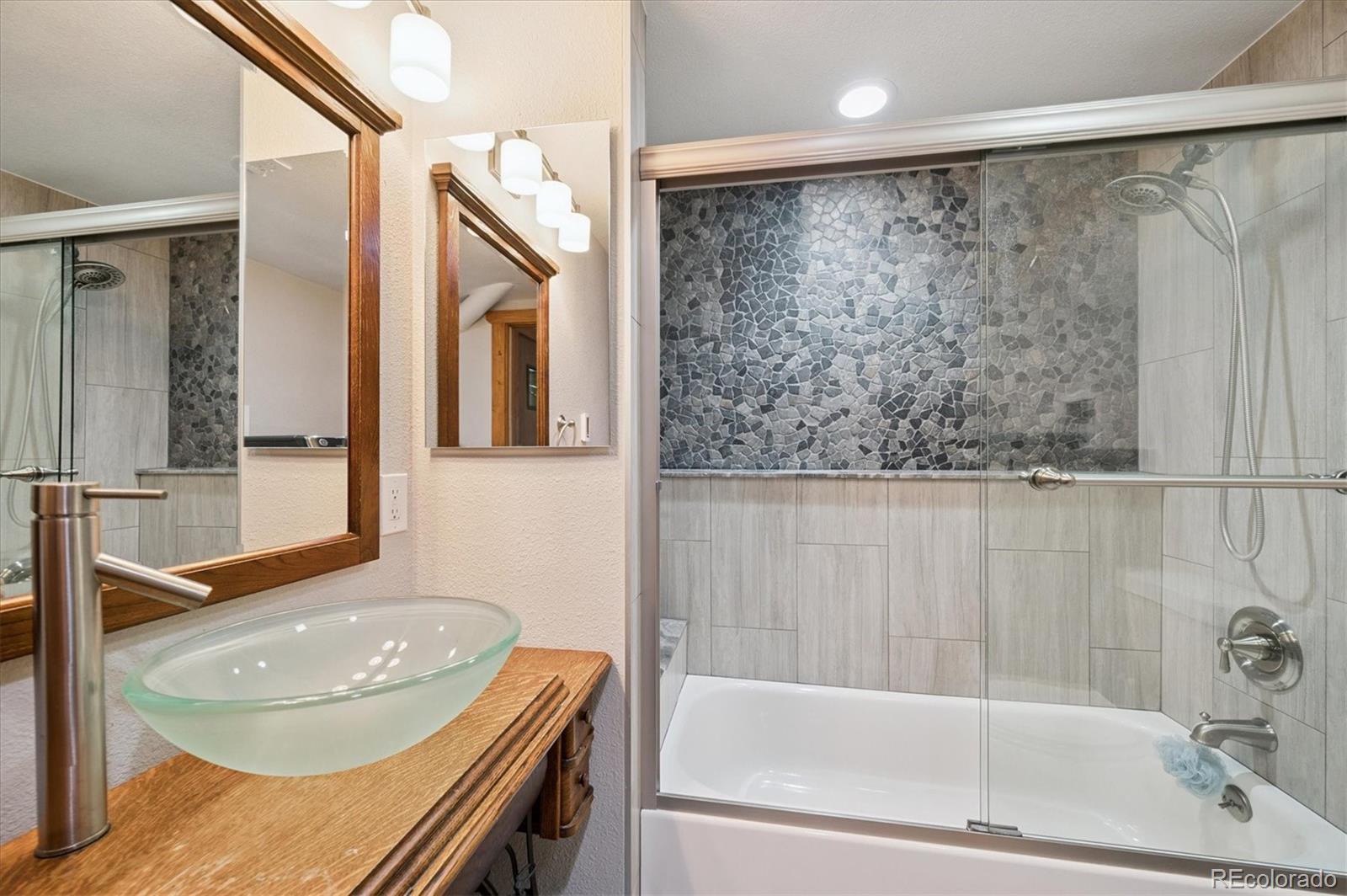 12369 Quartz Spur Conifer, CO 80433 - Photo 19 of 36 a bathroom with a granite countertop sink and a bathtub