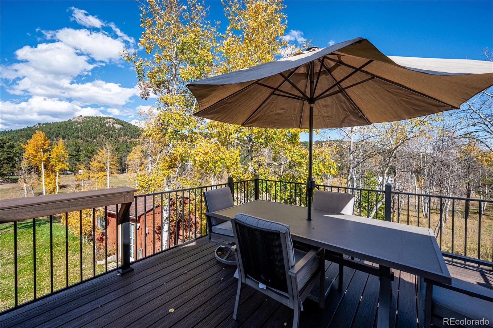 12369 Quartz Spur Conifer, CO 80433 - Photo 26 of 36 a view of a chairs and table in the balcony
