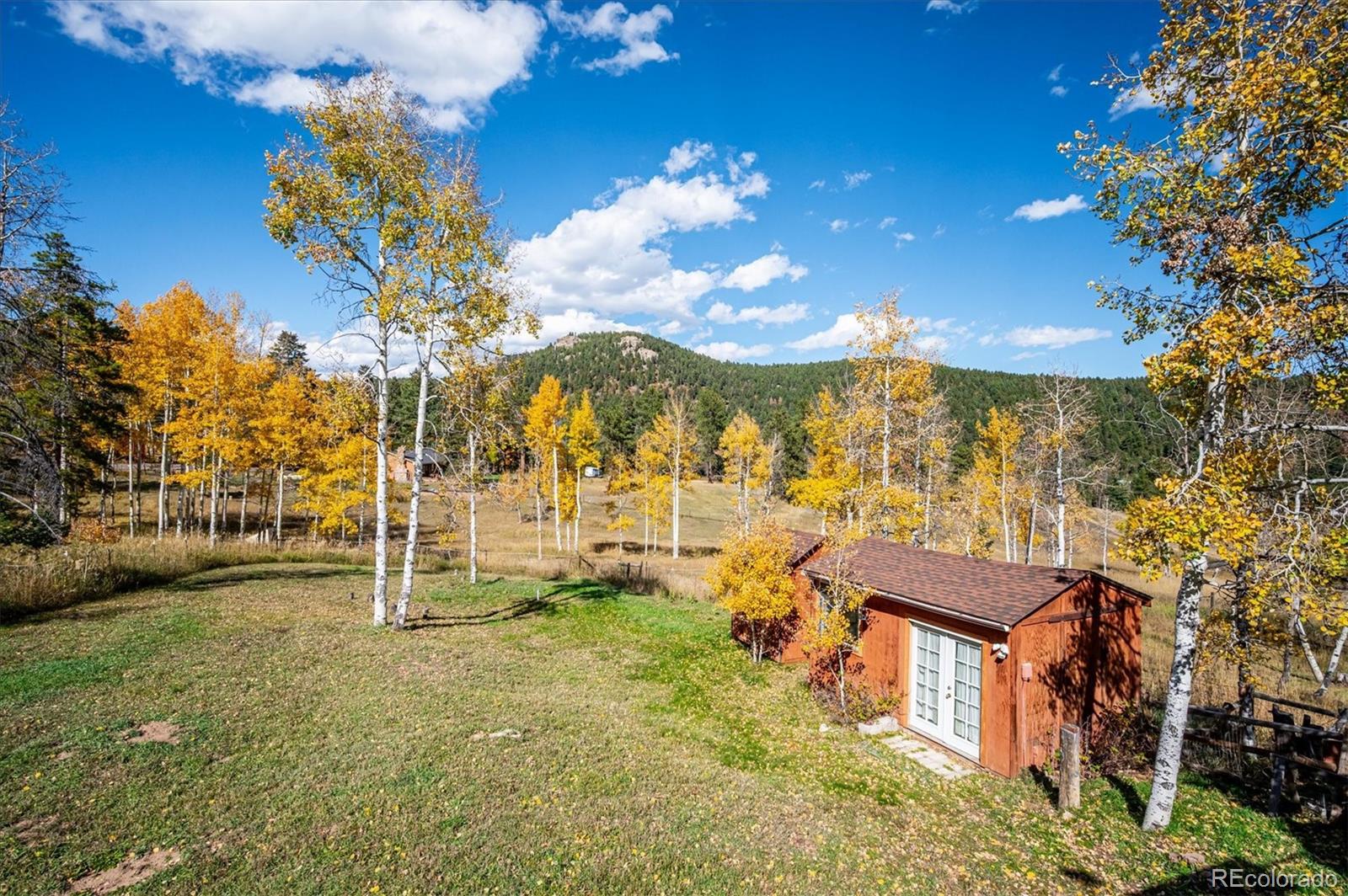 12369 Quartz Spur Conifer, CO 80433 - Photo 27 of 36 a view of a house with a yard