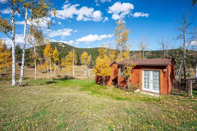 a view of a house with a large tree