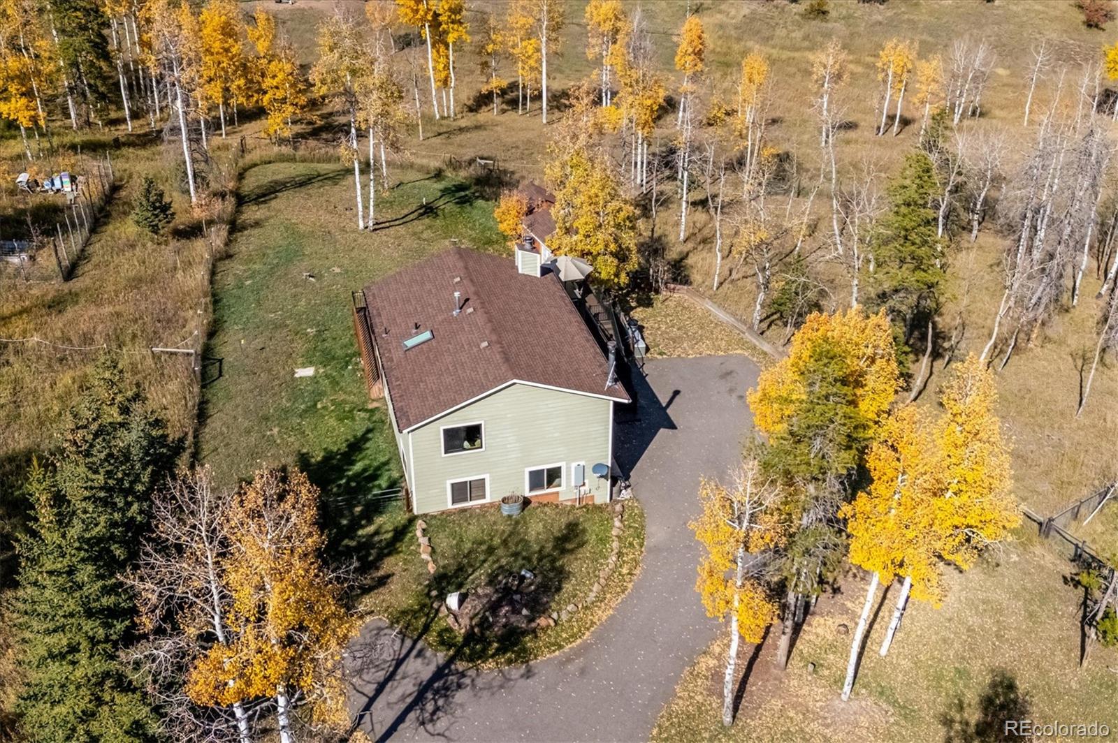 12369 Quartz Spur Conifer, CO 80433 - Photo 34 of 36 an aerial view of residential house with swimming pool and lawn chairs
