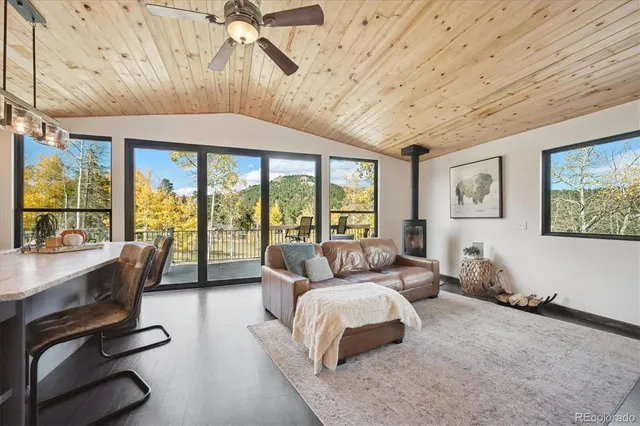 a bedroom with a bed and large windows